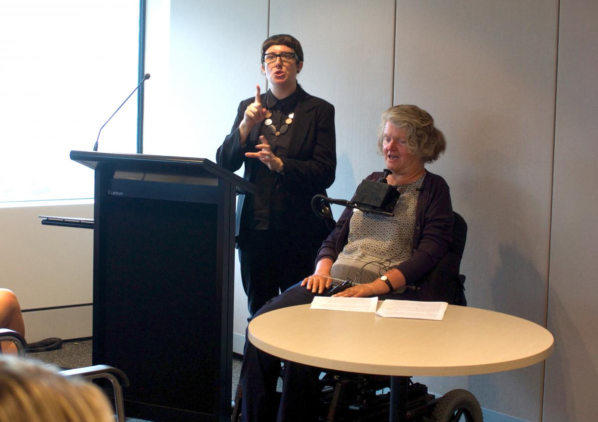 Rosemary Keys (right) and Auslan interpreter at the podium
